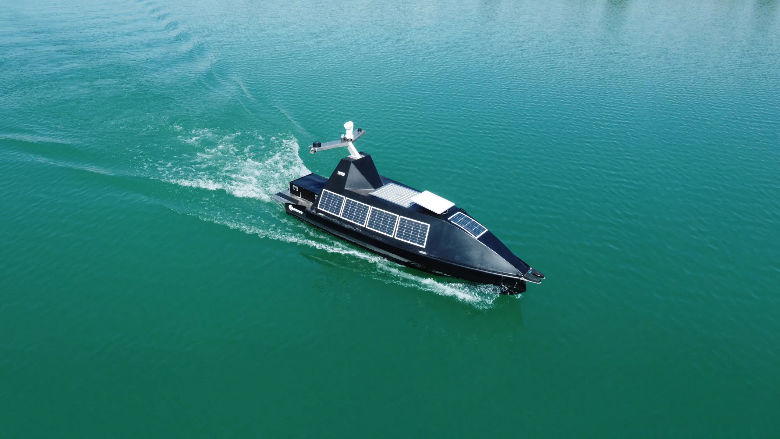 Lemvos LM450 uncrewed surface vessel underway offshore, seen from the air
